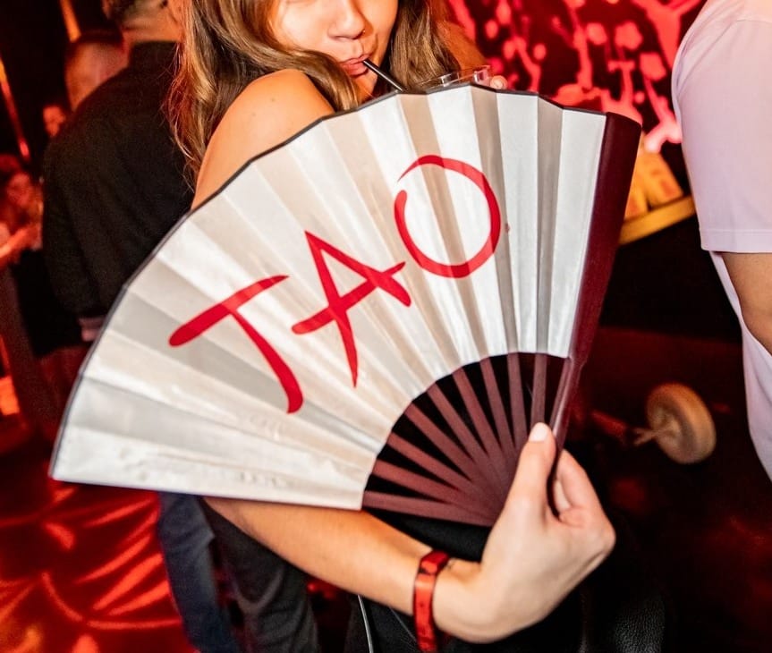 girl-holding-a-tao-branded-fan