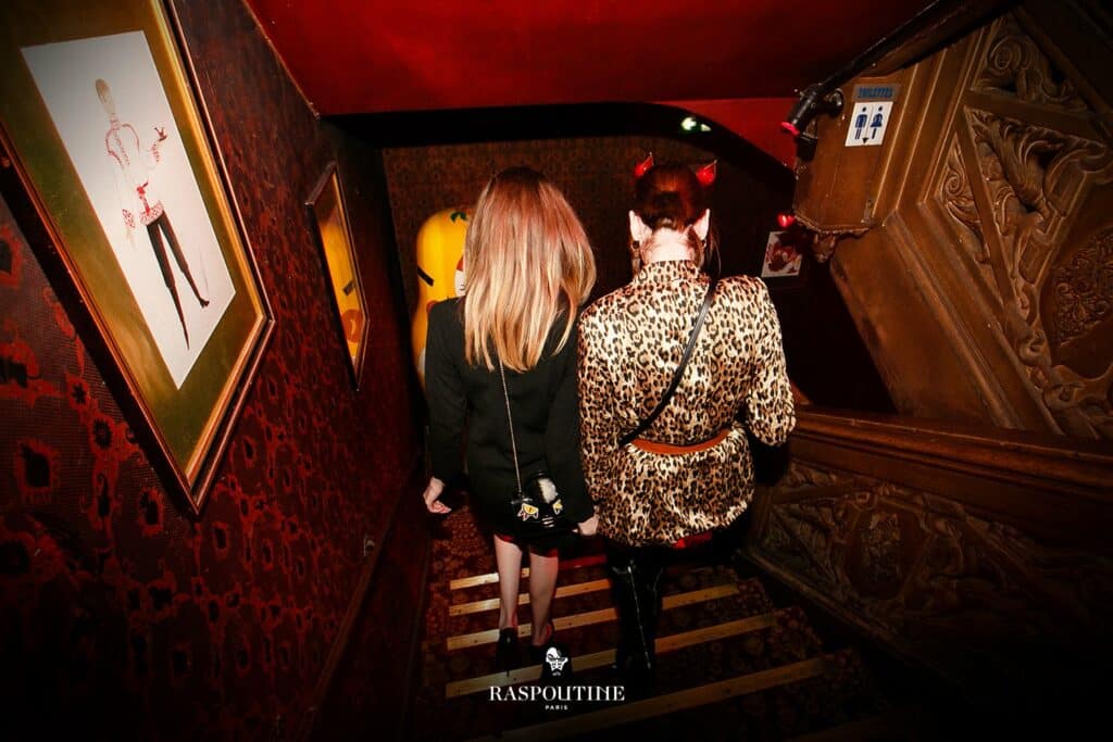 two-girls-climbing-stairs-at-raspoutine-paris